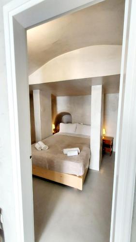 a bedroom with a large bed in a room at Olympic Villas in Oia