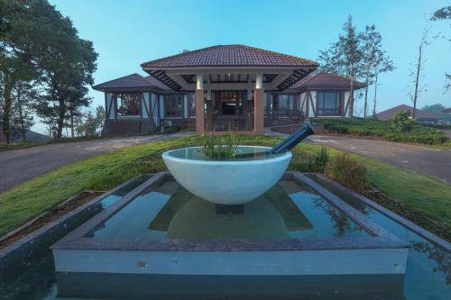 a large white bowl in front of a house at Jeevess Retreat Wayanad in Wayanad