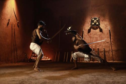 a couple of men playing a game of bow and arrow at Jeevess Retreat Wayanad in Wayanad