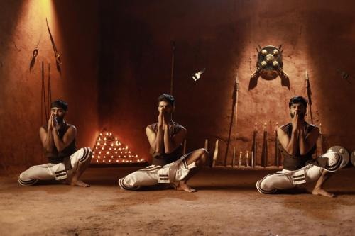 a group of three men sitting in a room at Jeevess Retreat Wayanad in Wayanad