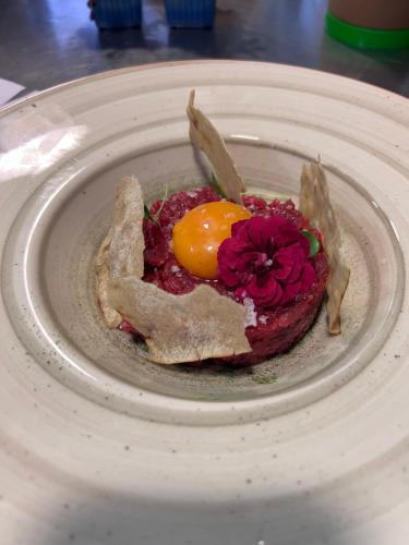 a plate with an egg and flowers on it at Brissago Lake Apartment in Brissago