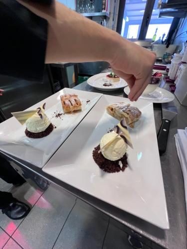 a person is reaching for a plate of desserts at Brissago Lake Apartment in Brissago