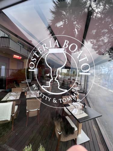 a restaurant with a sign that reads china bowl and city and town at Brissago Lake Apartment in Brissago