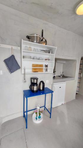 a small blue table in a small kitchen at Olympic Villas in Oia