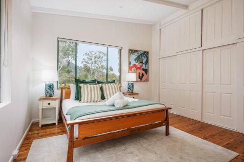 a bedroom with a bed and a window at The Riverstone Luxury Eco Home in the Hills in Mudgee