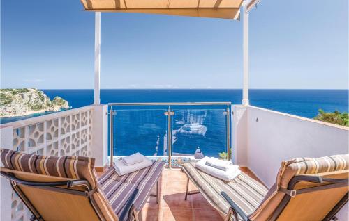 two chairs on a balcony with a view of the ocean at Costa Nova in Jávea