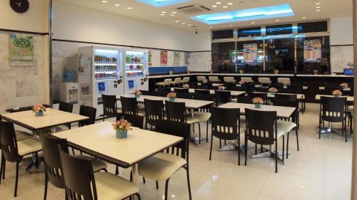 a dining room with tables and chairs in a restaurant at Toyoko Inn Tokyo Akiba Asakusabashi-eki Higashi-guchi in Tokyo