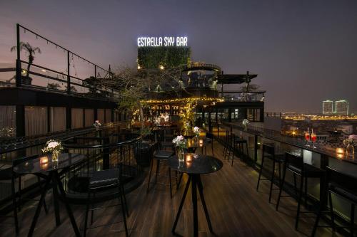 a rooftop bar with tables and chairs on a building at La Nueva Boutique Hotel Hanoi & Spa in Hanoi