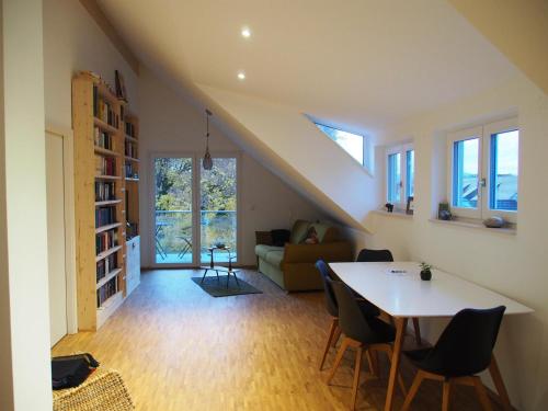 a living room with a table and chairs and a couch at N13 Living in Wangen im Allgäu