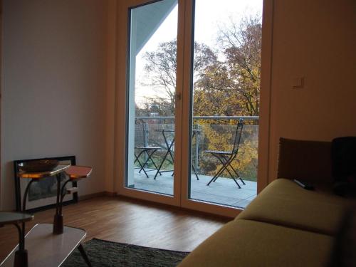 a living room with a sliding glass door with a balcony at N13 Living in Wangen im Allgäu