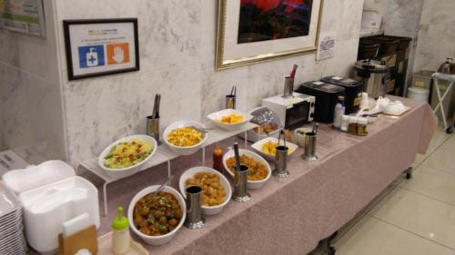 a buffet line with bowls of food on a counter at Toyoko Inn Tokyo Ueno Tawaramachi eki in Tokyo