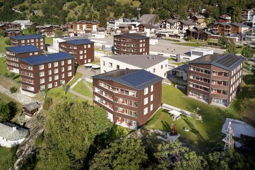 an aerial view of a small town with buildings at Reka-Feriendorf Blatten-Belalp in Blatten bei Naters