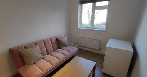 uma sala de estar com um sofá e uma mesa em 2 Bedroom Apartment in Kentish Town em Londres