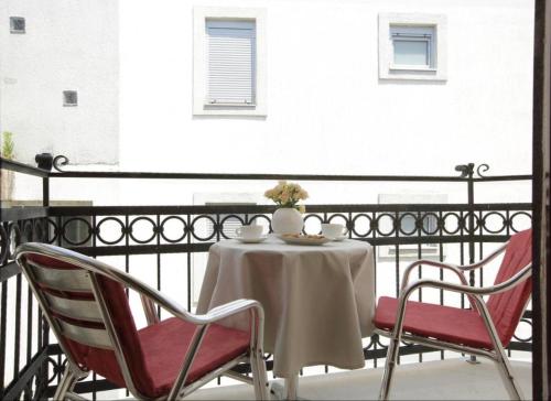 a table and chairs on a balcony at Vidikovac Budva in Budva