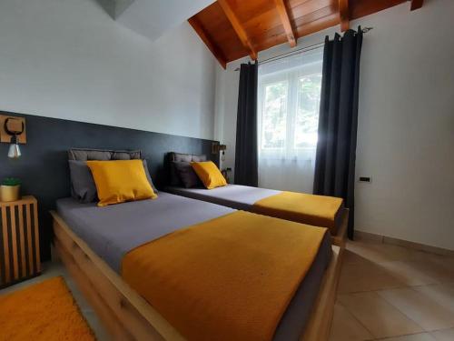 Duas camas com almofadas amarelas num quarto em Large apartment in Central Istria with private pool em Pulići