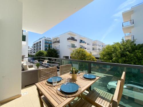a patio with a table and chairs on a balcony at Meia-Praia Beach & Town Marina Apartment #1923 in Lagos