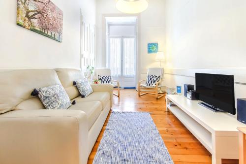 a living room with a couch and a flat screen tv at Lisbon Boulevard in Lisbon