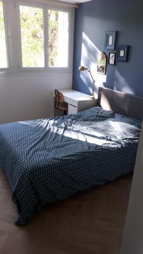 une chambre avec un lit et un bureau avec une lampe dans l'établissement Le Mangin - Rent4night Grenoble, à Grenoble
