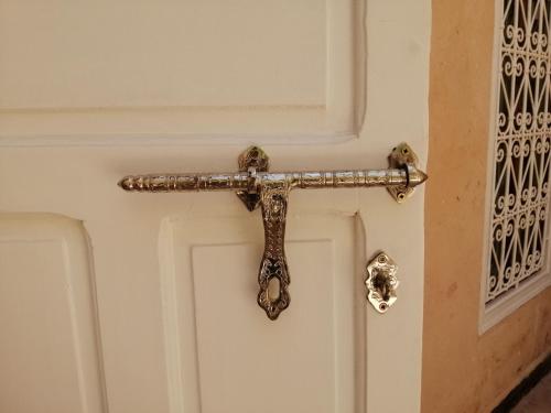 a door handle attached to a white door at Hostel Laksour in Marrakech
