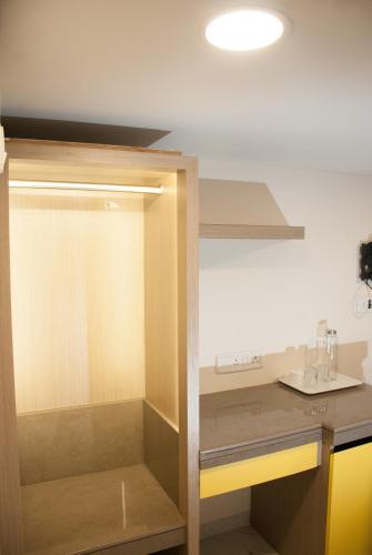 a kitchen with a counter with a glass door at City Hotel in Mumbai
