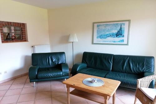 a living room with a couch and a table at Beekenhof in Bommelsen