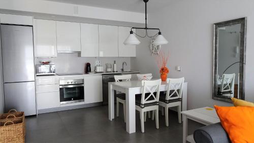 a kitchen with a table and chairs in a room at Sotavento Las Terrazas II, La Tejita in La Tejita