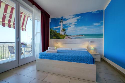 a bedroom with a bed with a view of the ocean at The Lighthouse Rooms in Lazise