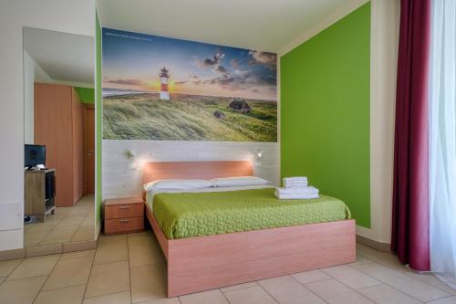 a bedroom with a bed with a painting on the wall at The Lighthouse Rooms in Lazise