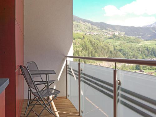 a balcony with two chairs and a view at Apartment Urgbach Apart-1 by Interhome in Landeck