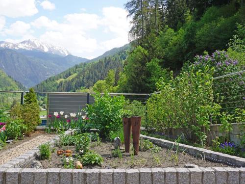 a garden with some plants and mountains in the background at Apartment Urgbach Apart-1 by Interhome in Landeck