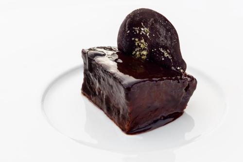 a piece of chocolate cake on a white plate at Hotel Saliecho in Formigal