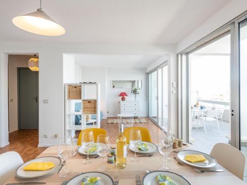 une salle à manger et un salon avec une table et des chaises dans l'établissement Apartment Les Arpèges-4 by Interhome, au Grau-du-Roi