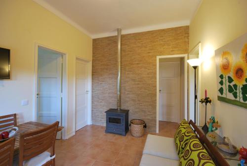 a living room with a fireplace and a stove at Casa do Cabril in Pedrógão Pequeno
