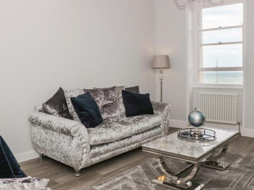 a living room with a couch and a coffee table at Royal Terrace View in Weymouth