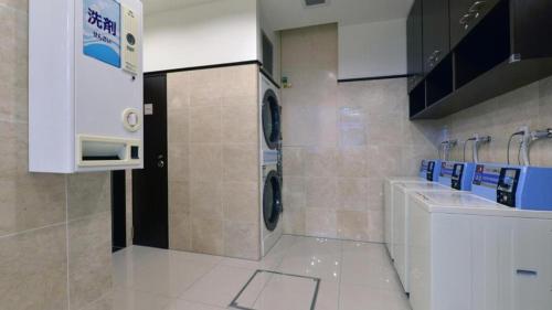 a bathroom with a washer and dryer in a kitchen at Toyoko Inn Tokyo Asakusa Kuramae No.2 in Tokyo