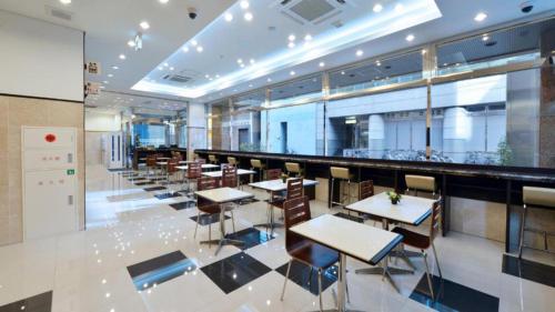 a restaurant with tables and chairs and a bar at Toyoko Inn Tokyo Asakusa Kuramae No.2 in Tokyo