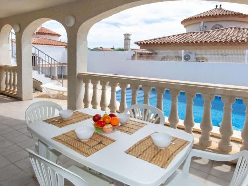 a white table with a bowl of fruit on a balcony at Holiday Home Villa Kikidona by Interhome in Miami Platja