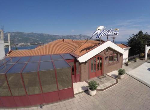 a building with a sign on top of it at Vidikovac Budva in Budva