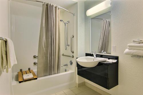 a bathroom with a sink and a shower at Motel 6-Kingsville, TX in Kingsville