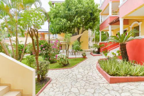a courtyard of a building with trees and plants at Parco del Caribe in Boca Chica