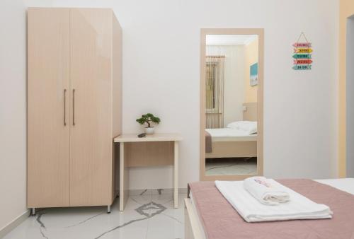 a bedroom with a bed and a mirror at Villa Božica - sea view stone villa with free parking in Makarska