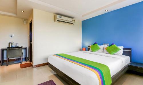 a bedroom with a large white bed with a rainbow at Treebo Concerto Residentia in Durgāpur
