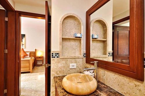a bathroom with a sink and a mirror at Acanto Hotel Playa del Carmen, Trademark Collection by Wyndham in Playa del Carmen