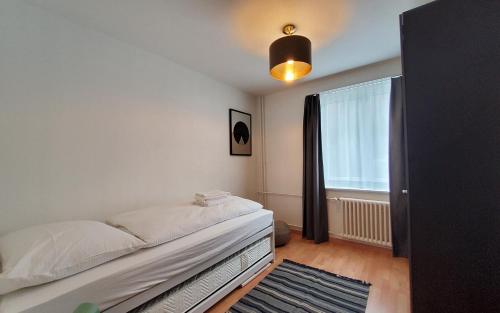 a bedroom with a bed and a window at Apartment Via Surpunt - Bella - 3 Rooms in St. Moritz