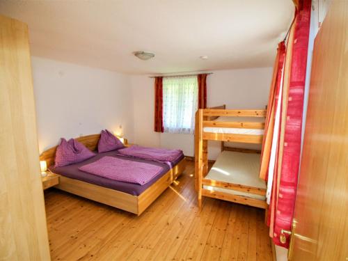 a bedroom with a bed and a bunk bed at Holiday Home Krechen Alm by Interhome in Pernegg an der Mur