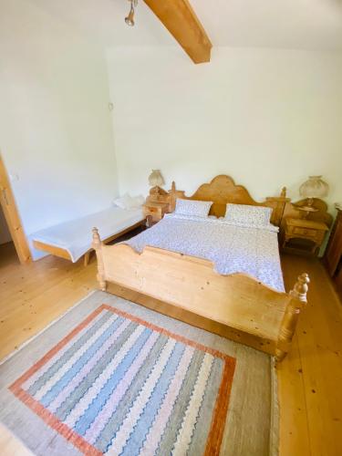 a bedroom with a wooden bed and a rug at Chata Paradise in Smižany