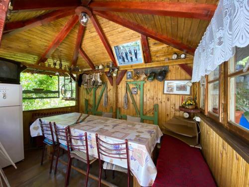 a room with a table and chairs in a house at Pensiunea Mioritica in Sibiel