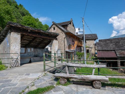 a wooden bench sitting in front of a building at Chalet Baita Degli Orsi - DOD110 by Interhome in Murata
