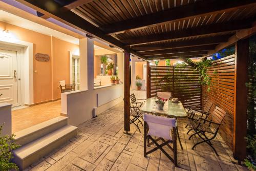 a patio with a table and chairs on it at Lorenzo Villas with Private Pool, 200m from the beach, by ZanteWize in Lithakia