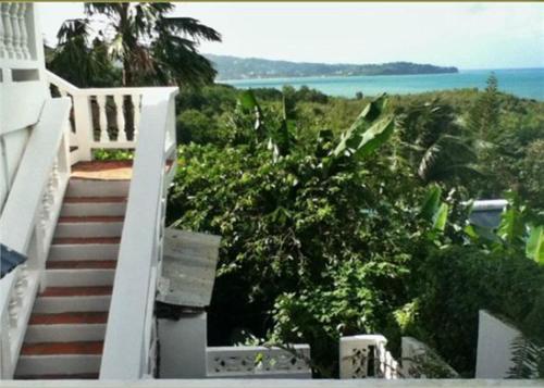 a staircase leading to a house with a view of the ocean at Apartment Espoir in Castries